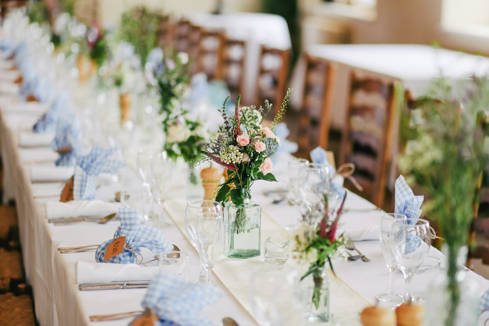 Elegant wedding ceremony setup with white chairs and a floral arch